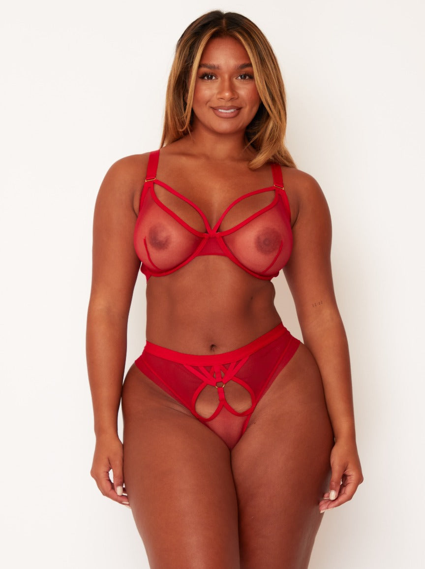 Woman wearing a red lingerie set on a white background
